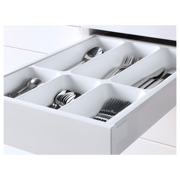 White kitchen drawer organiser with multiple compartments holding cutlery. Part of the METOD kitchen system, designed for clean, modern storage.