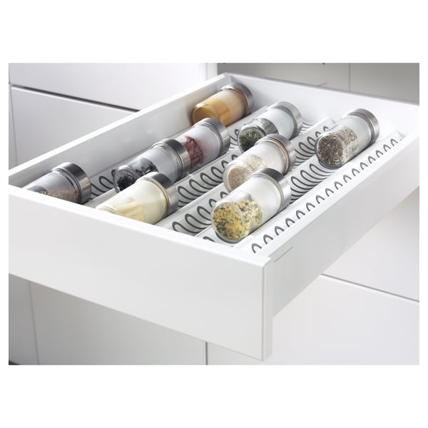 White kitchen drawer organiser with multiple spice jars, part of the METOD system.