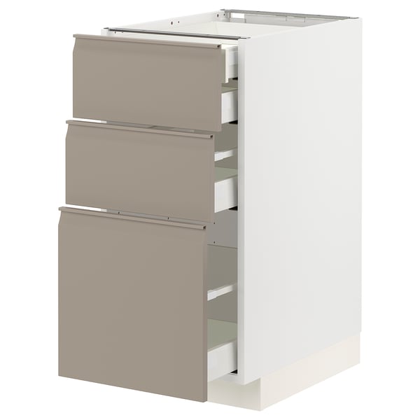 Modern kitchen cabinet with matte grey-beige drawers, three-drawer design, integrated handles, and soft-close feature.