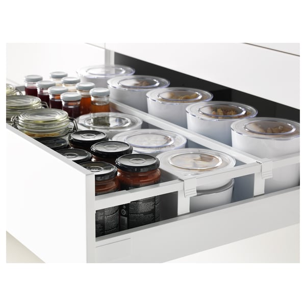 Kitchen drawer with multiple jars and containers. Self-closing mechanism and smooth runners.