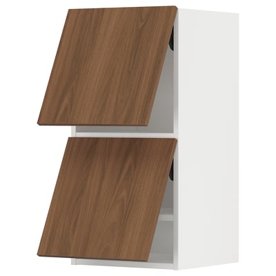 A white kitchen cabinet with two wooden doors in a walnut finish. The design is sleek and modern, featuring a smooth surface with simple lines.