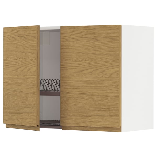 A wooden kitchen wall cabinet from the METOD system, featuring oak-colored doors with a minimalist design and integrated handles.