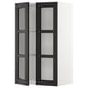 Black & white METOD kitchen cabinet with glass doors and bevelled edges.