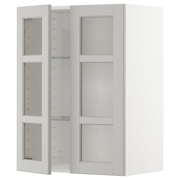 A white METOD kitchen cabinet with glass doors. It has a rectangular shape with three adjustable shelves inside.