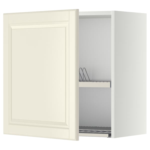 Off-white kitchen cabinet with bevelled edges, open door showing metal dish drainer, creamy, rectangular.