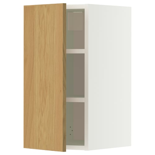 A METOD wall cabinet with a light oak door and white frame. It has three adjustable shelves and is mounted on the wall.