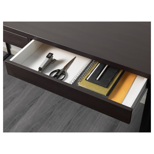 Office drawer with scissors, clips, and notebooks, showing organised workspace.