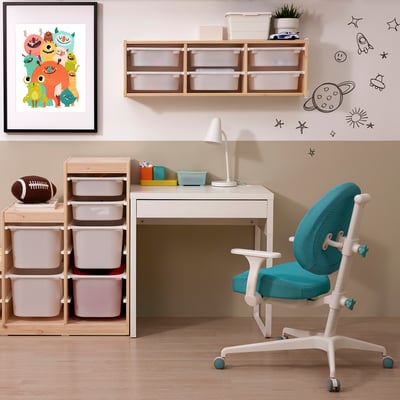 MICKE desk setup: small white desk with storage, turquoise chair, wooden shelf with coloured drawers. Bright decor, kid-friendly design.