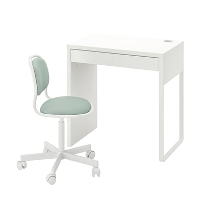A white desk with a single drawer and a green cushioned chair with wheels.