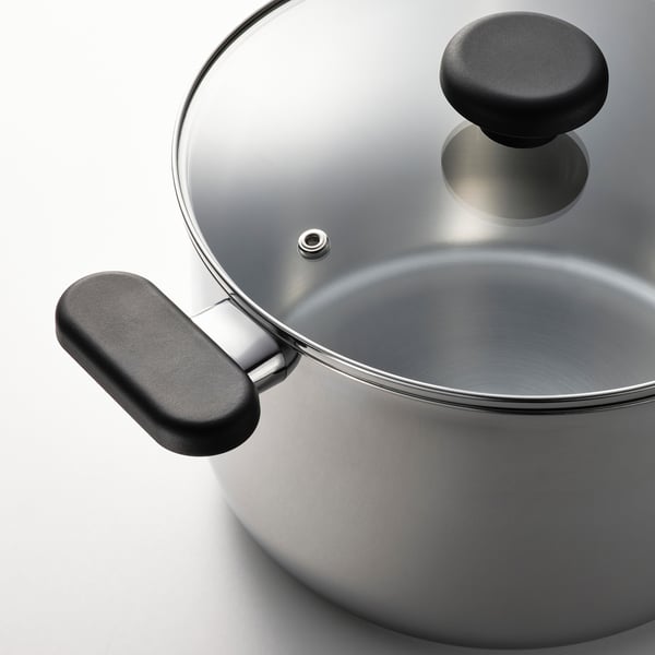 Silver saucepan with glass lid and black handles, reflecting quality and durability.
