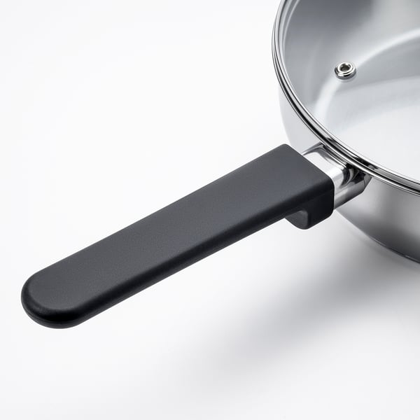 Stainless steel sauté pan with black handle, robust and sleek design, ideal for various hobs including induction.