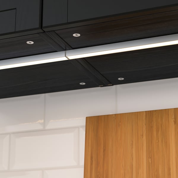 Modern kitchen lights provide even, warm illumination. Under-cabinet lighting brightens workspace efficiently.
