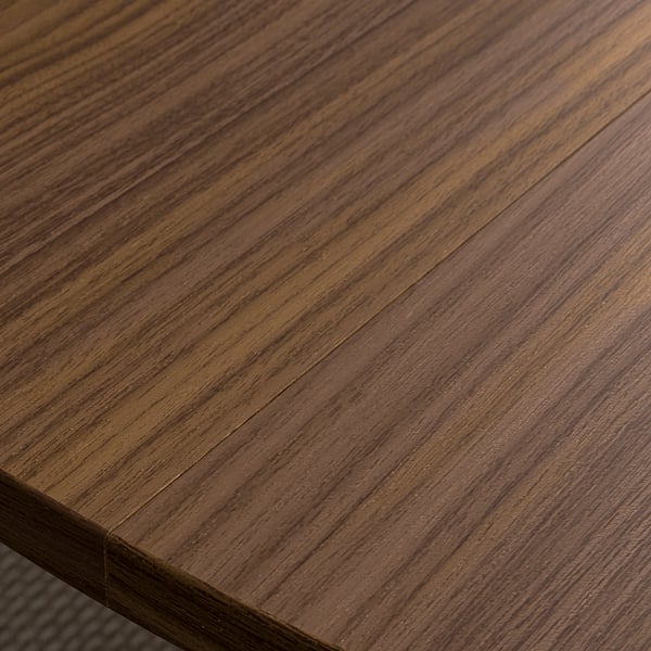 Close-up of a smooth, polished wooden tabletop with rich, dark grain patterns, reflecting light gently, giving a sense of high-quality craftsmanship.