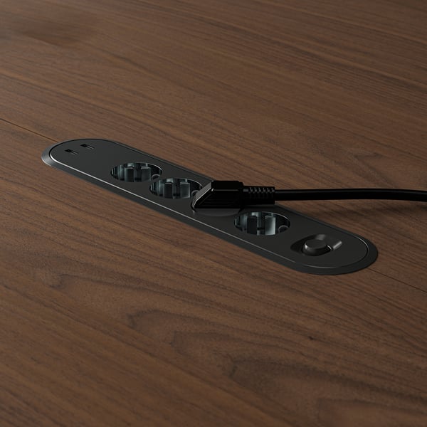 Oval power hub on table, usb slots, ethernet port, corded.