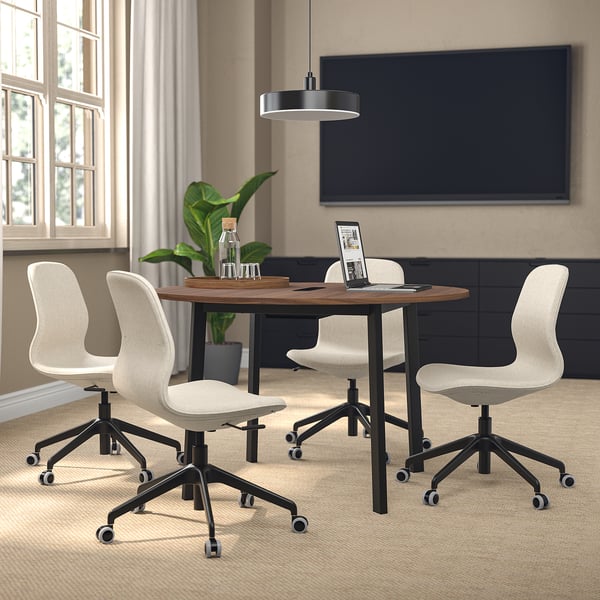 MITTZON round conference table with 4 chairs, compact for small meetings, wooden top, metal base, screen nearby.
