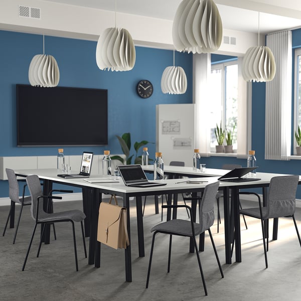 Modern conference room with MITTZON tables, pendant lights, and blue accent wall.