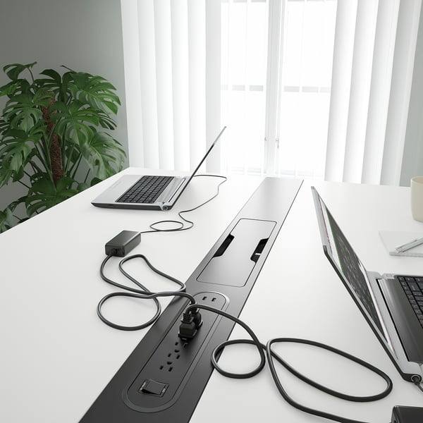 Modern conference table with integrated power strips, usb ports, and neatly managed cables for efficient meetings.