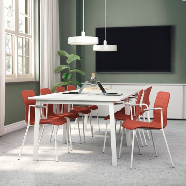 Mitzon conference table with red chairs in modern office.