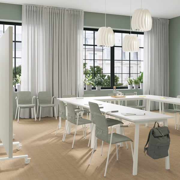 Modern office with MITTZON tables, chairs, and plants. If necessary, you can further shorten it: modern office with MITTZON tables and plants.