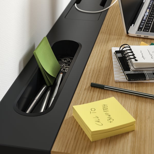 Organised desk setup with MITTZON height-adjustable desk. Includes pen holder with sticky notes and a notebook for productivity.