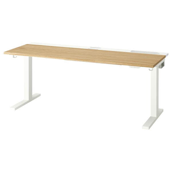 A MITTZON sit/stand desk with a light wood top and white legs. It dual motors and adjustable height.