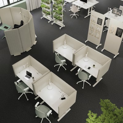 Modern office with MITTZON sit/stand desks, green chairs, and plants.