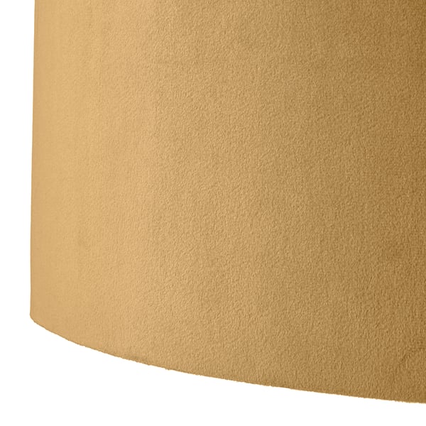 Close-up view of a soft, textured, gold lampshade. Velvet material provides warmth and depth to the surface.