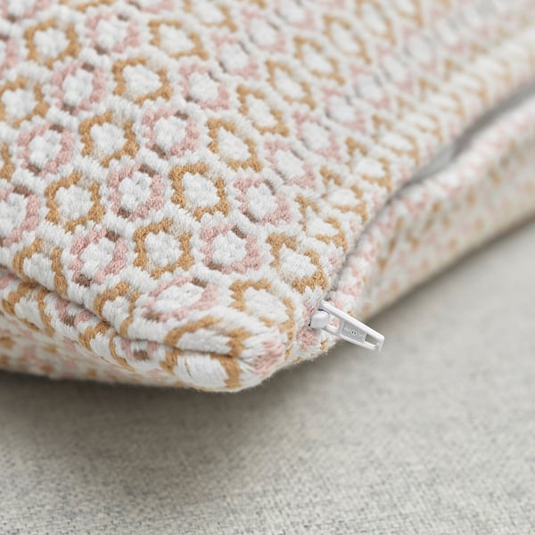 Close-up of a textured, yarn-dyed cushion cover with intricate weave pattern. Visible zip indicates easy removal.