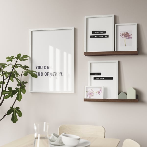 Wall-mounted picture ledges with motivational prints. Shelves display art and memories.