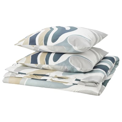 Abstract leaf bedding set in white, beige, blue on cotton-viscose, folded with pillows.