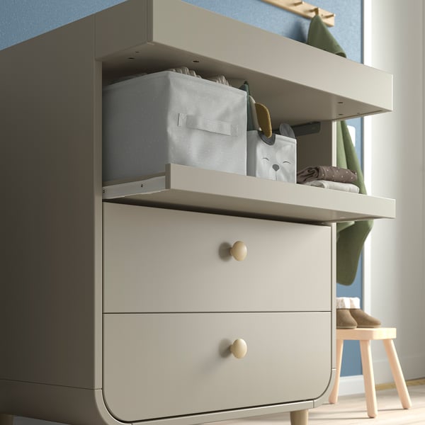 Changing table with shelves and drawers, perfect for baby essentials.