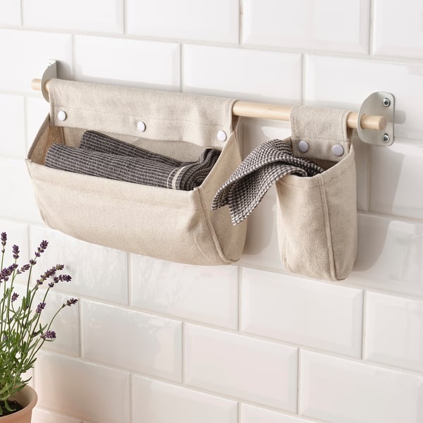 Wall storage basket with towels, freeing counter space.