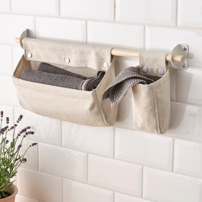 Wall storage basket with towels, freeing counter space.
