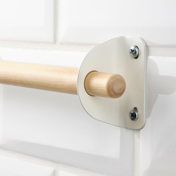 Close-up of high-quality wooden rod, securely mounted with white metal brackets using screws.