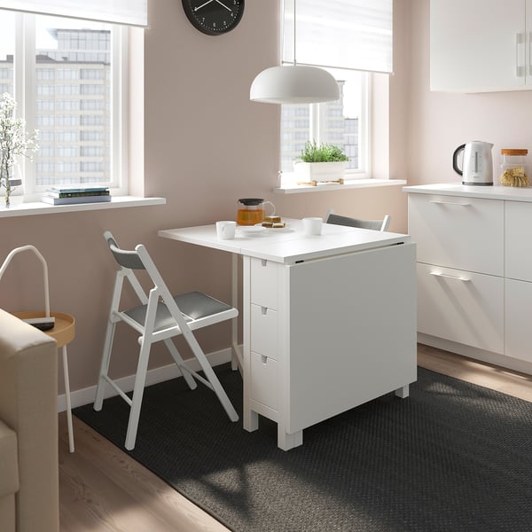 Modern white NORDEN drop-leaf table with grey chairs. Compact, fits small spaces, stylish.