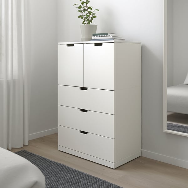 A minimalist white NORDLI storage unit with drawers and cabinets, fitting neatly into a bedroom corner. Smooth, silent drawers and a modern design.