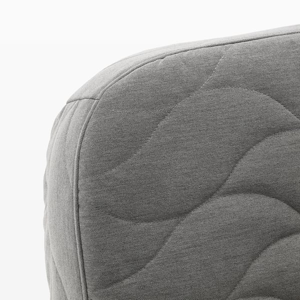 Soft, grey fabric detail of NYHAMN sofa-bed. Showing high-quality stitching and smooth texture.