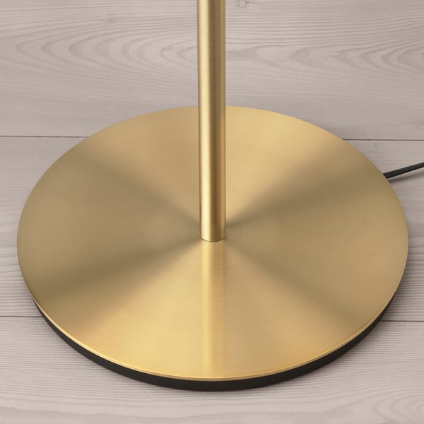 Gold lamp on light wood base.