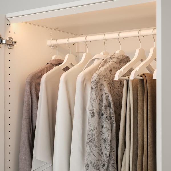 A well-lit closet with clothing on hangers. Led lights illuminate the space, making it easy to choose outfits.