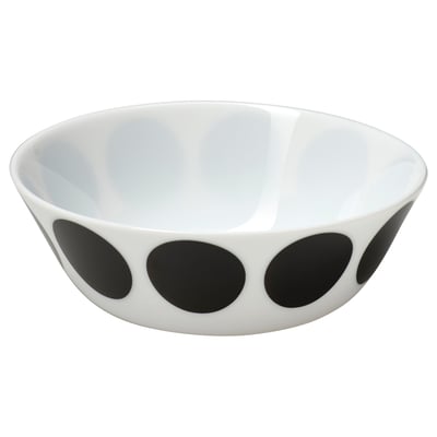 Black and white ceramic bowl with large circular dots on the exterior.