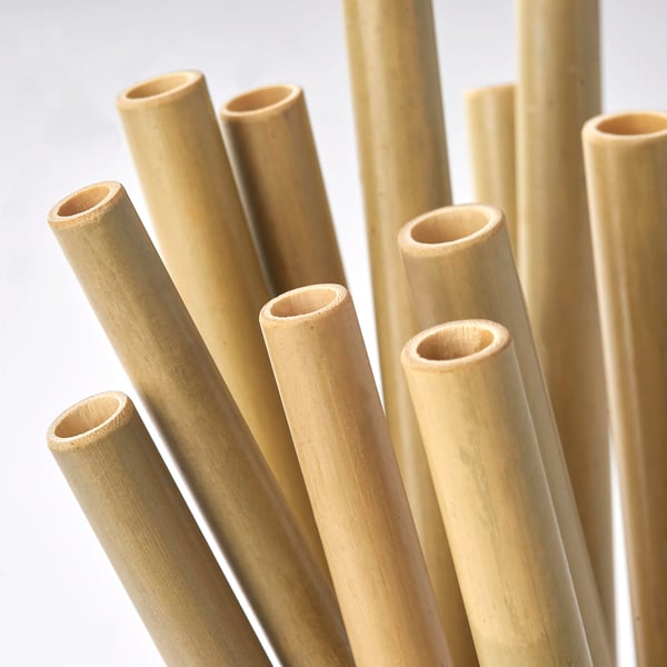 Multiple natural, smooth bamboo straws, neatly bundled, showcasing their uniform, eco-friendly quality.