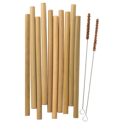 In a set of ten light brown bamboo drinking straws is displayed. To their right, two copper-colored cleaning brushes with metal handles are visible.