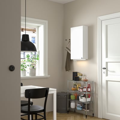 Kitchen corner with OMAR storage, chair, desk, and plant.