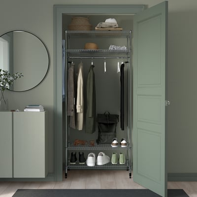 Green OMAR shelving unit in hallway, with clothes rail, shelves, and galvanised steel/plastic construction.