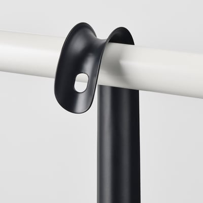 Black metal shoehorn attached to wall in modern design, part of OMTÄNKSAM collection.