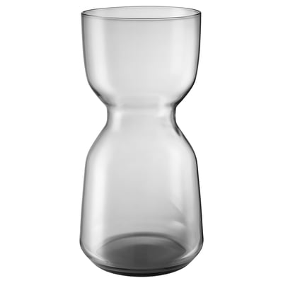 A clear glass vase named OMTÄNKSAM with a sleek, curved shape, designed for fresh flowers and easy handling.