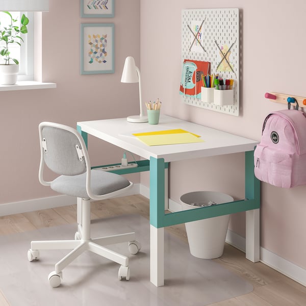 PÅHL white desk with teal accents in kids room. Small, adjustable, and neat with a backpack and plant nearby.