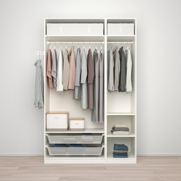 A white PAX wardrobe organises clothes with hanging rails, shelves, and baskets. Hinged door closes softly.