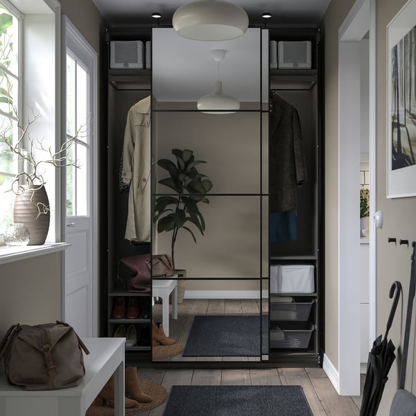 Modern entryway with PAX wardrobe, mirrored sliding doors, hanging coats, shelves, and a rug.