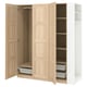An open PAX wardrobe in oak, featuring both shelves and hanging compartments.